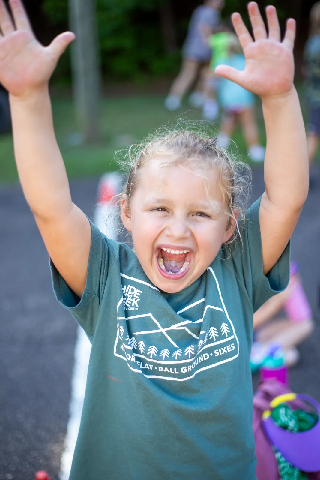 Camper cheering with both arms in the air
